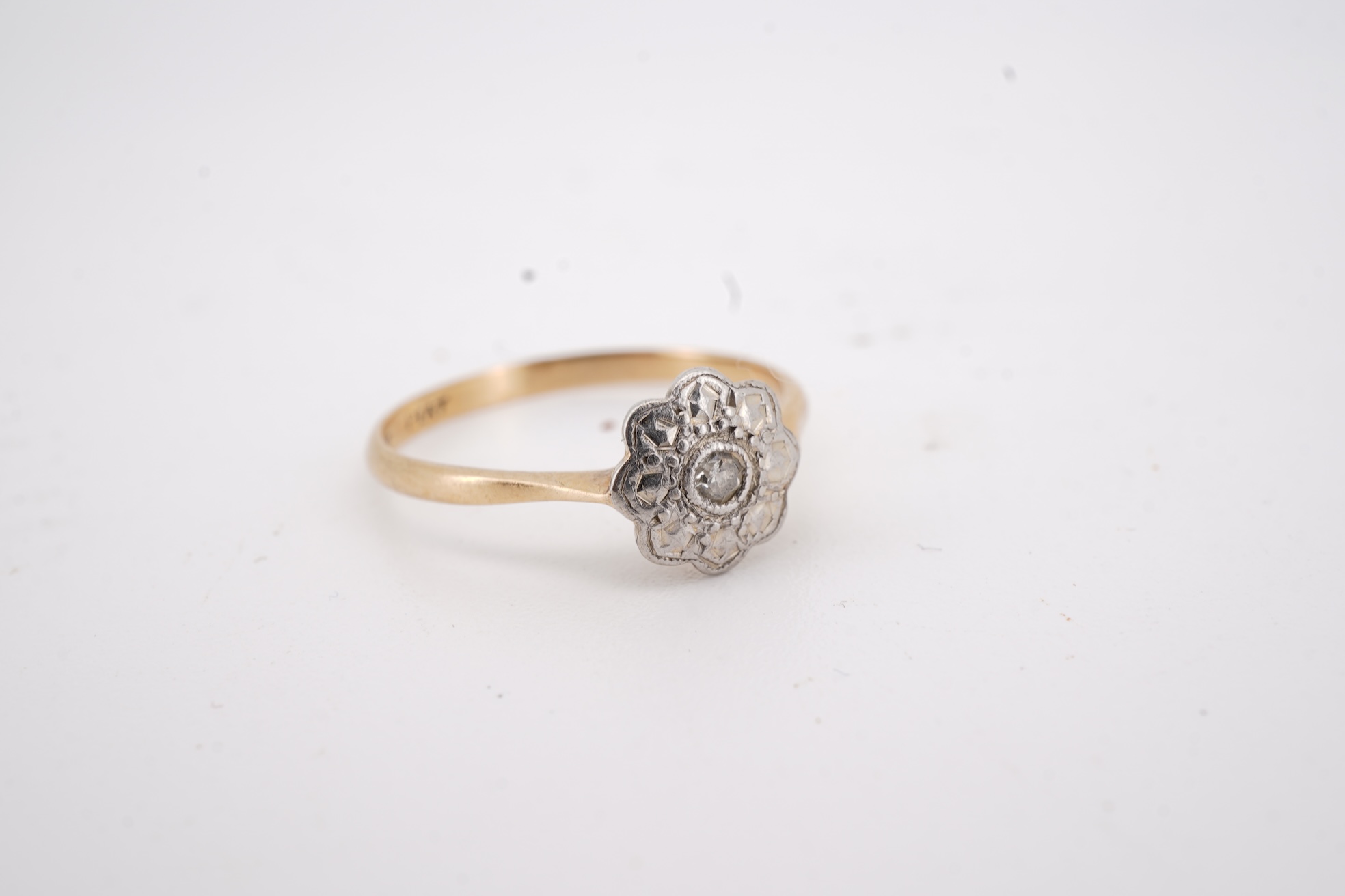 Three rings, comprising: a platinum wedding band, size N1/2, stamped PLAT, gross weight 3 grams; a bicoloured band, size J, stamped PLATINUM 22CT, gross weight 3 grams; and a ring set with a diamond weighing approximatel